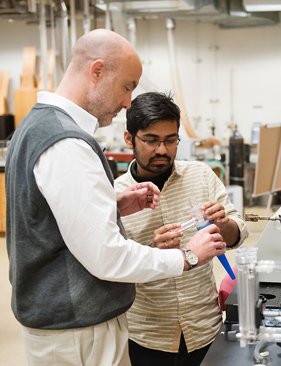 Professor and student in lab working.