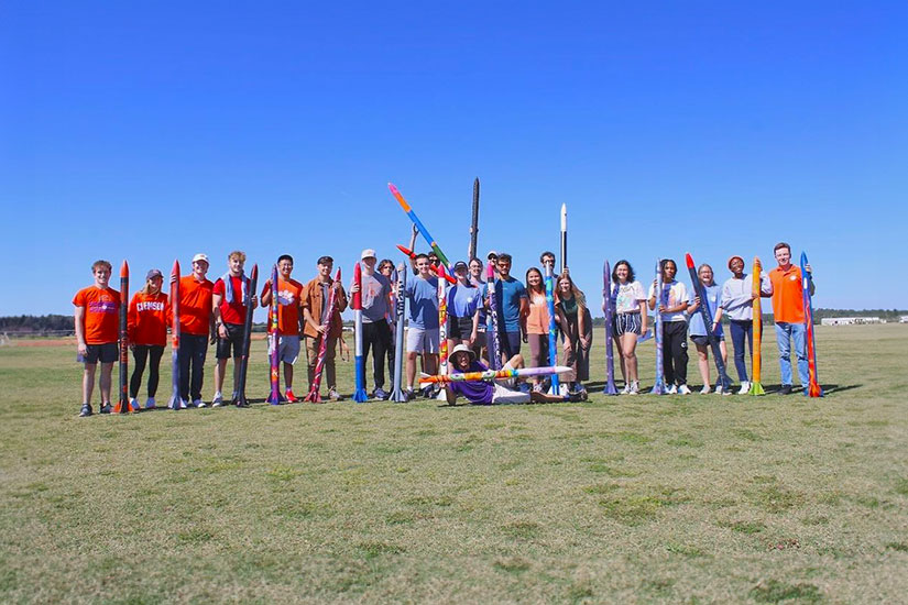 Rocket Engineering group holding rocket.