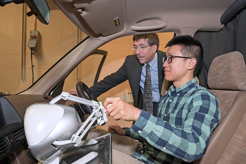 John Wagner with student in test vehicle.