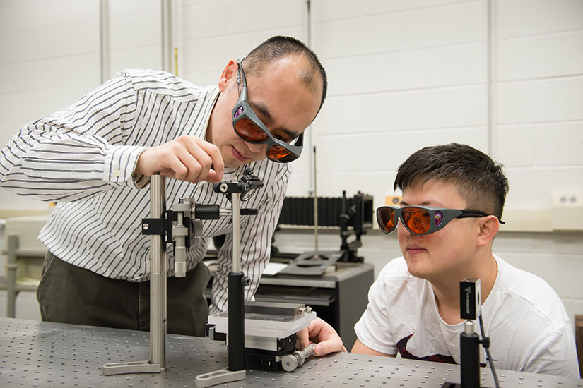 Xin Zhao with student in lab