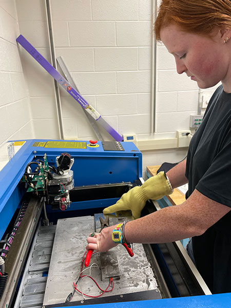 Student using UAS Solder equipment