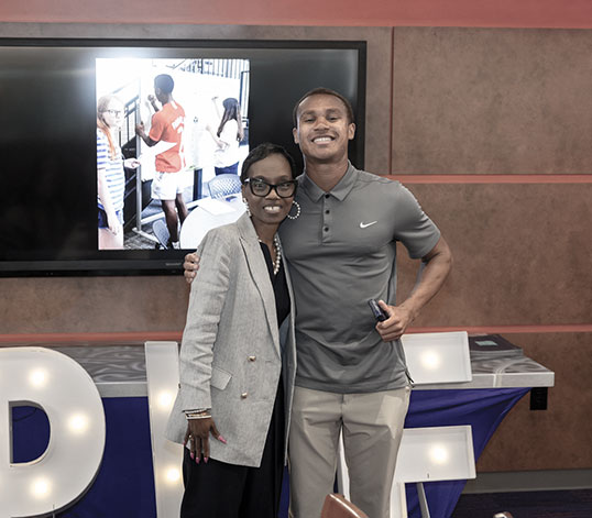 Student hugging Lisa at PWE celebration