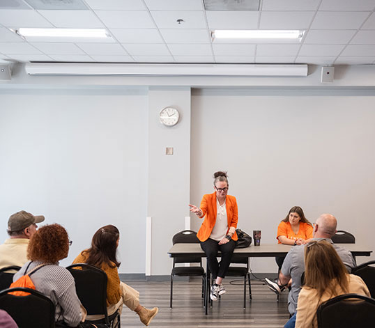 Speaker holding a session in a classroom in front of parents