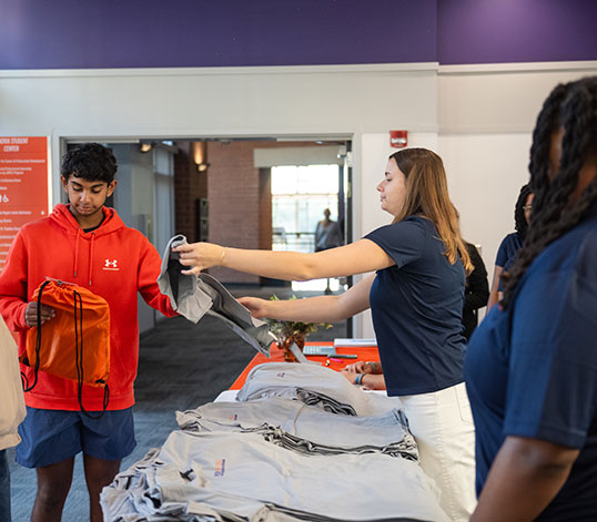 Student receiving swag before going into event.
