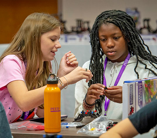 Two participants helping each other with project