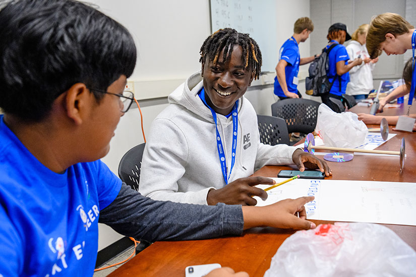 Two summer program participants working on engineering project.