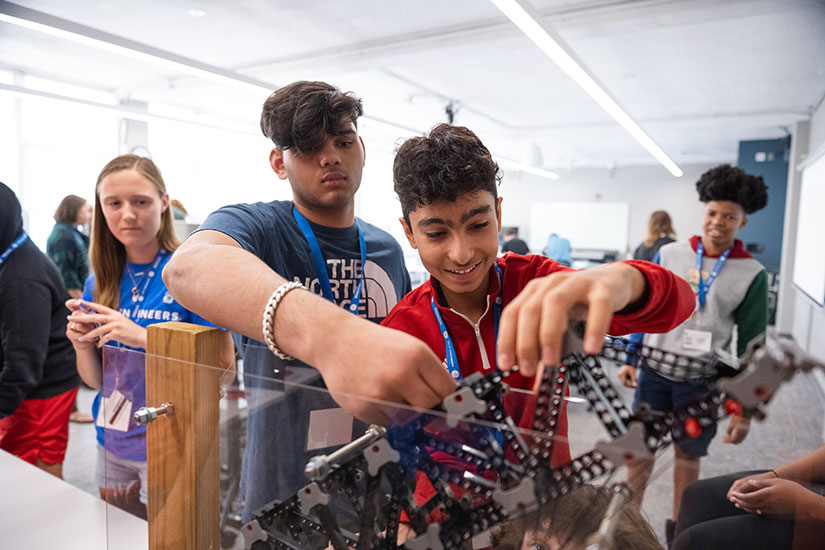 Group of students testing bridges