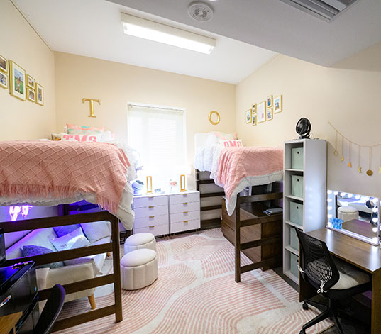 Inside dorm room, showing two beds and furniture