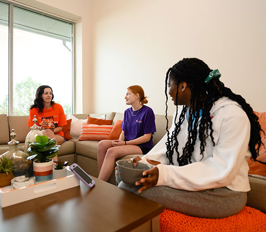 Three WISER students talking in open area of dorm