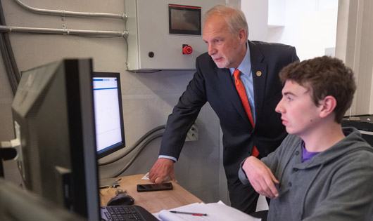 two researchers looking at computer screen