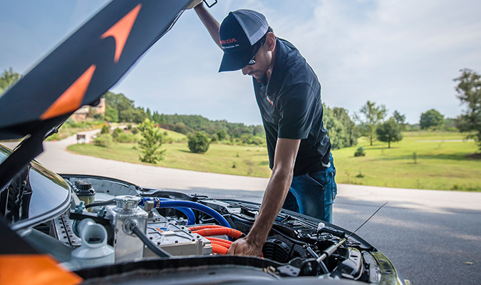 Student works under the hood of a Deep Orange car