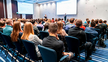 Attendees listen to a presenter