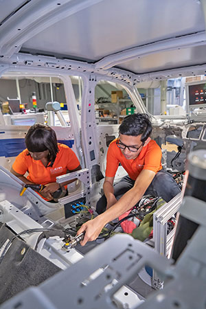 Male and female student in experimental car.
