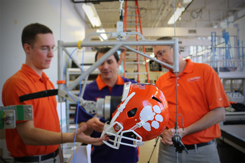Dr. Gregory Batt, Packaging Science, and Dr. John DesJardins, Bioengineering performing helmet testing