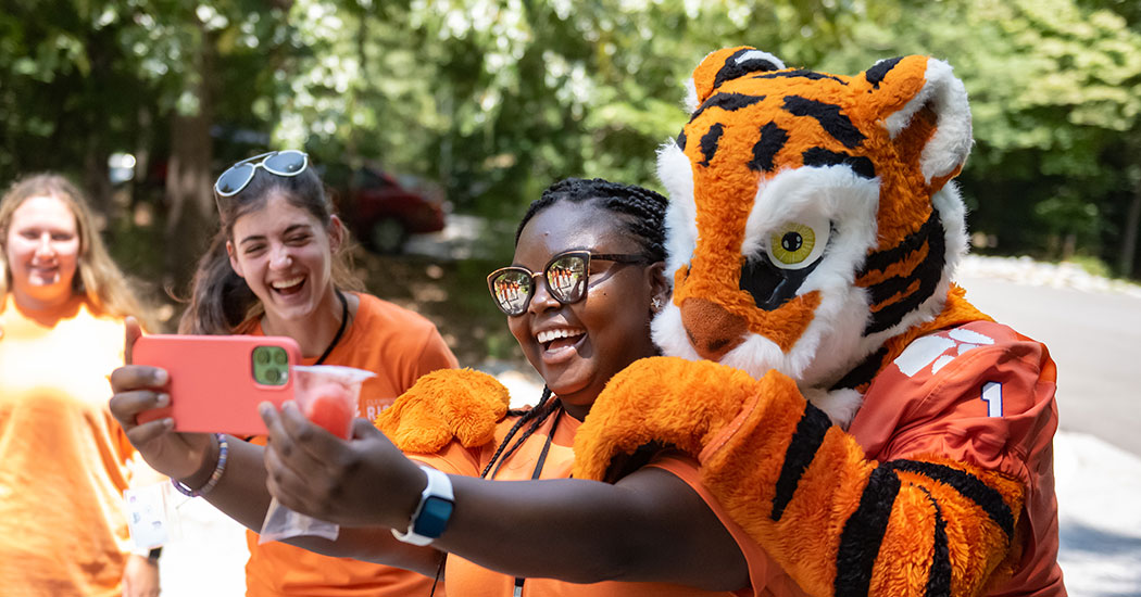 Students at RISE BASECAMP posing with tiger mascot.