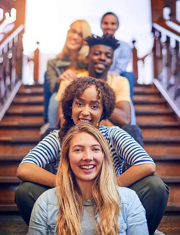 Mixed group of students sitting on stairs