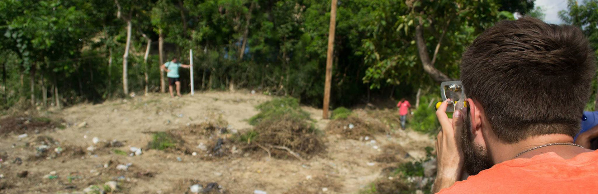 Students using surveying equipment in Haiti