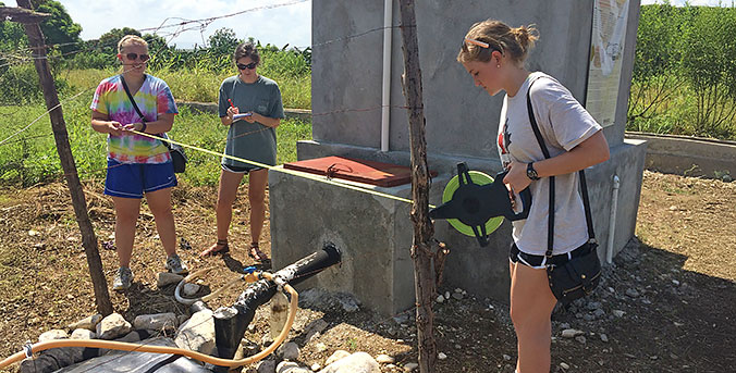 Three interns working on water project