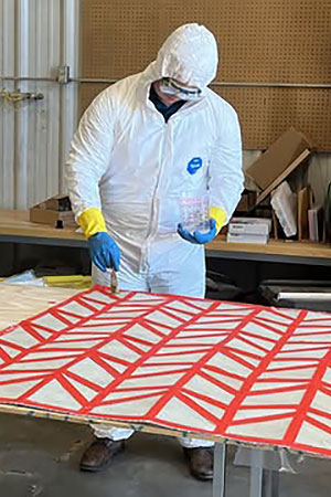 Student in protective suit working on origami project