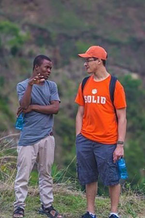 A student is having a discussion with a man from Hait