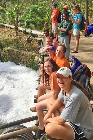 Group of students smiling at camera while in Haiti