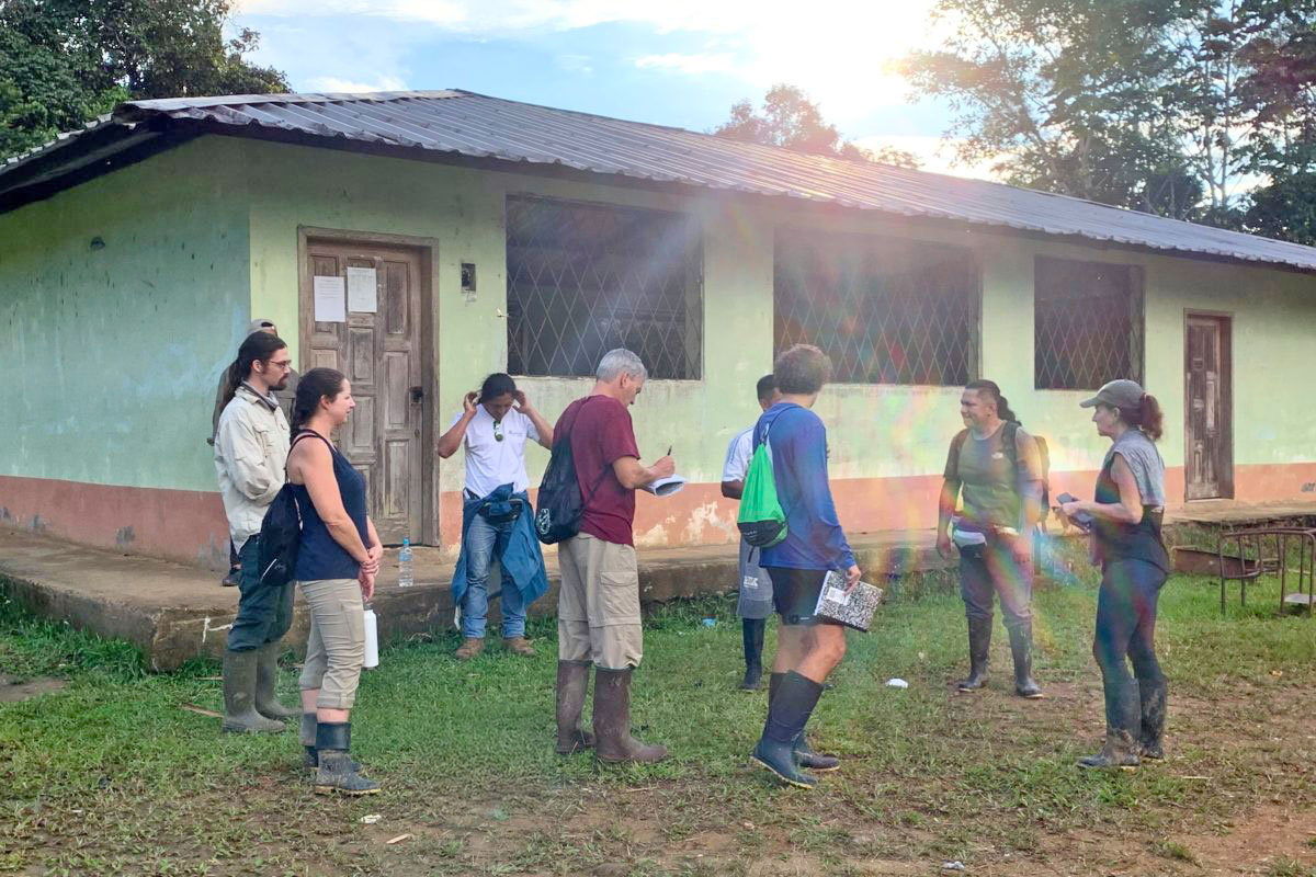 Group outside of building discussing Mandri Panga project