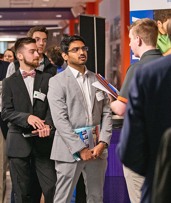 Male talking to recruiter at career fair