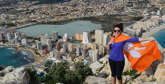 Travel abroad student with Clemson rag.