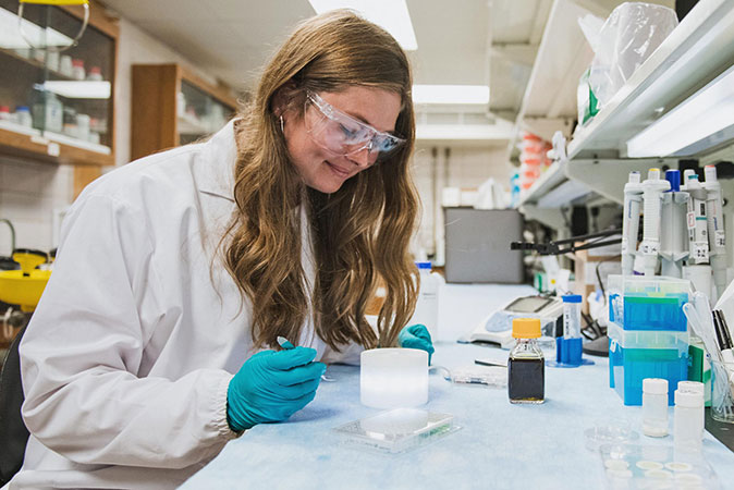 Female student performing lab work.