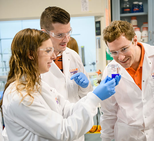 Female and male student with research professor