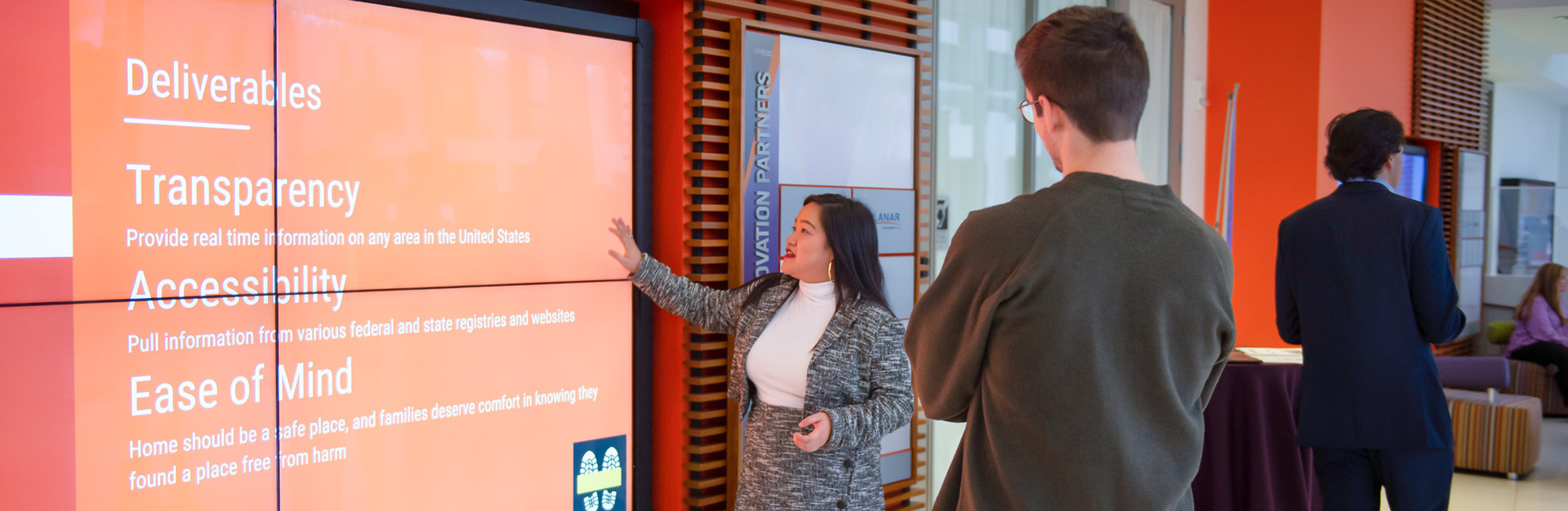 A student presents her idea in front of a screen