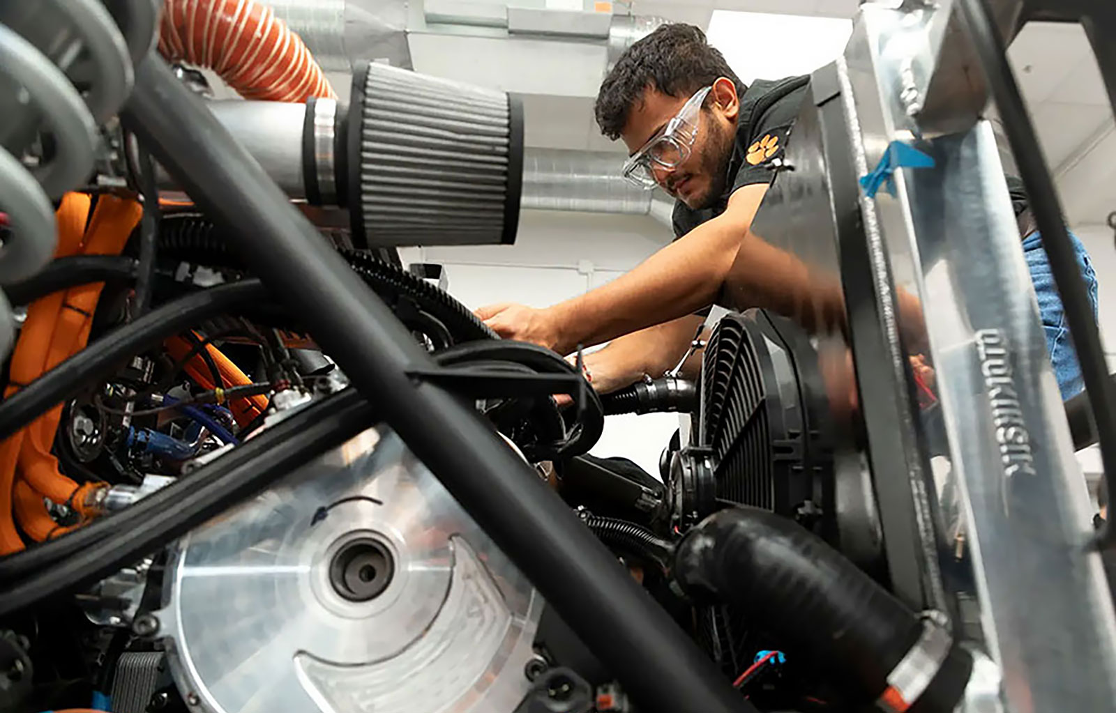Student working on vehicle prototype's internal components