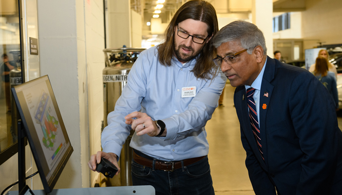 Faculty member inspecting parts