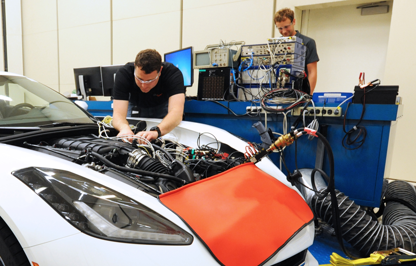 Professor working in side hood of vehicle