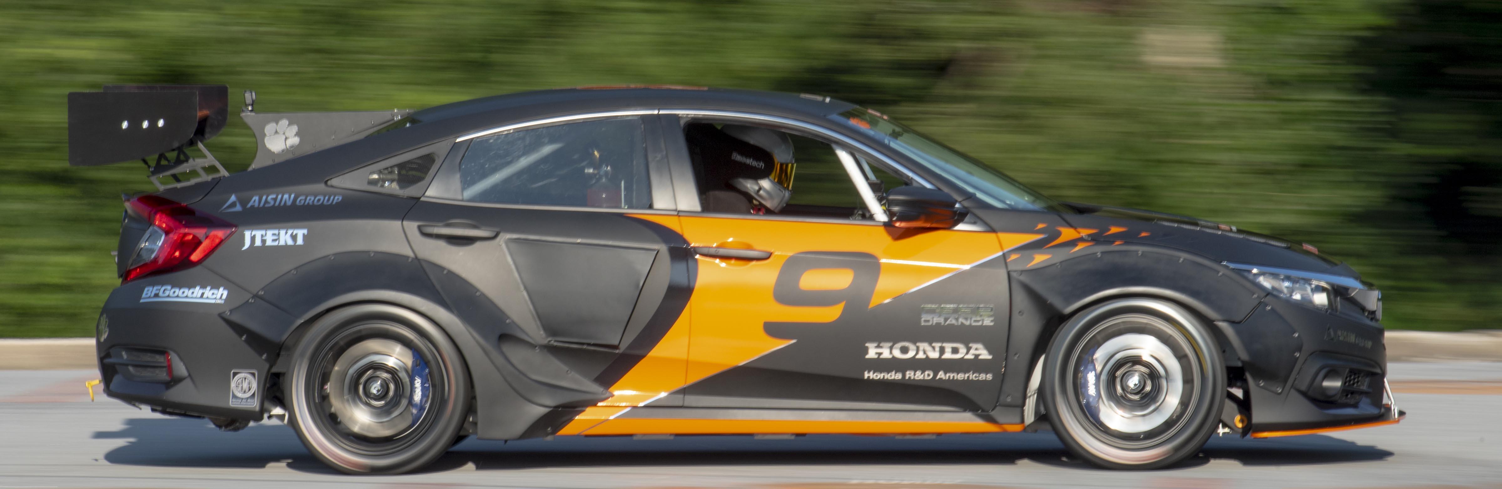 A Clemson research racecar accelerates and the background is a blur