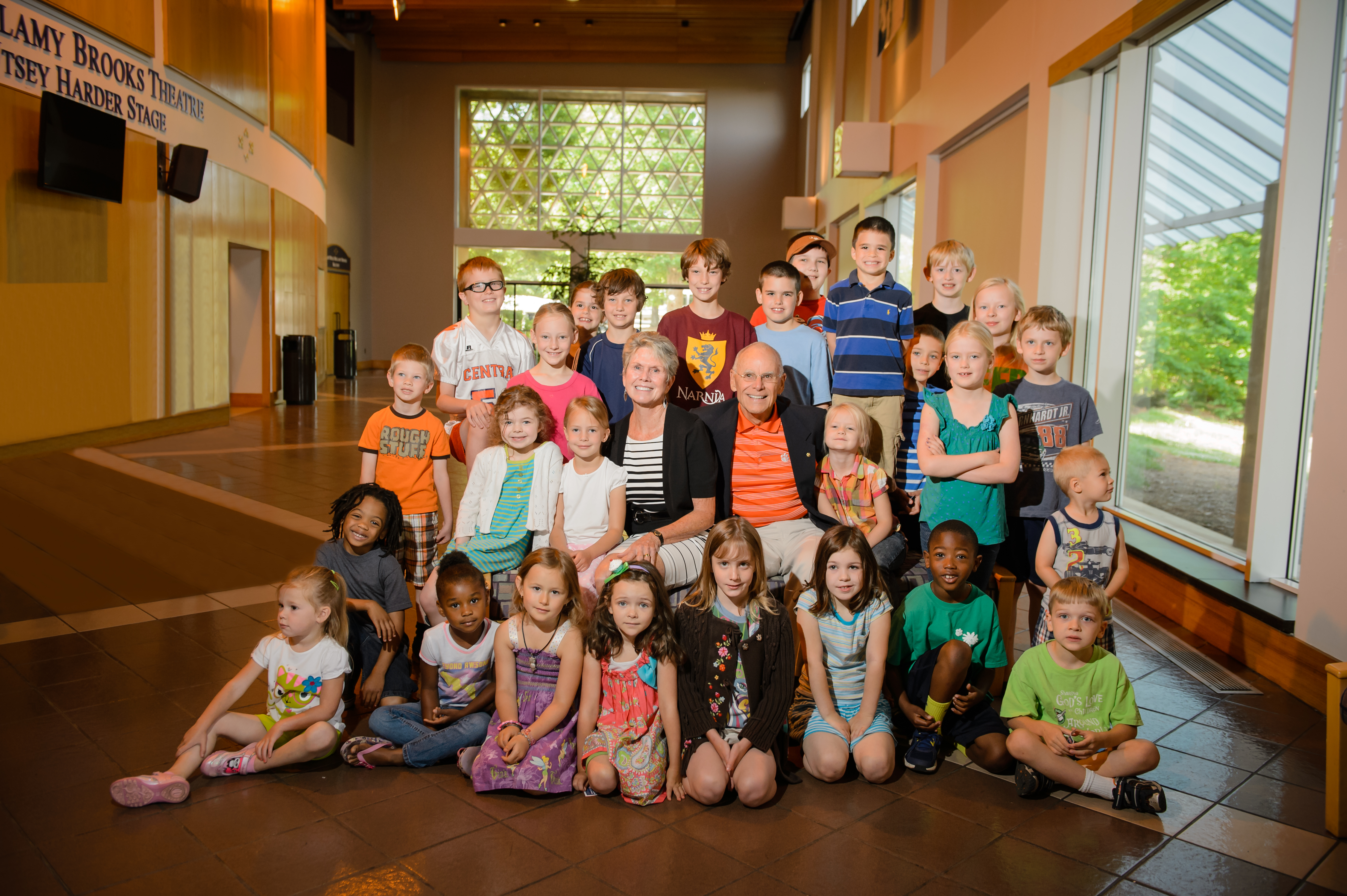 Bill and Donna Eskridge pose with local elementary school children in the Brooks Center lobby.