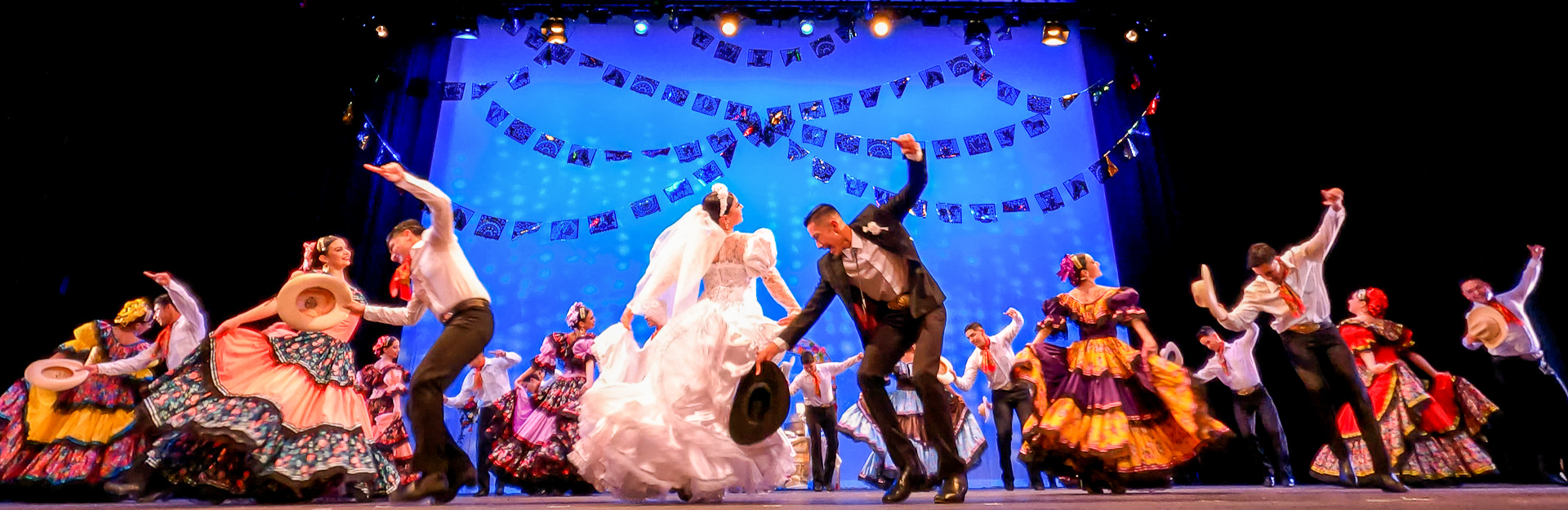 Production photo from ¡Fiestas de Mexico! The cast performs a lively and colorful traditional Mexican wedding dance
