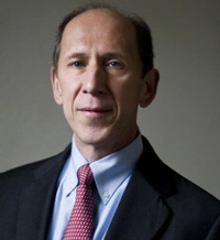 Professional portrait of a middle-aged man in a suit and tie.