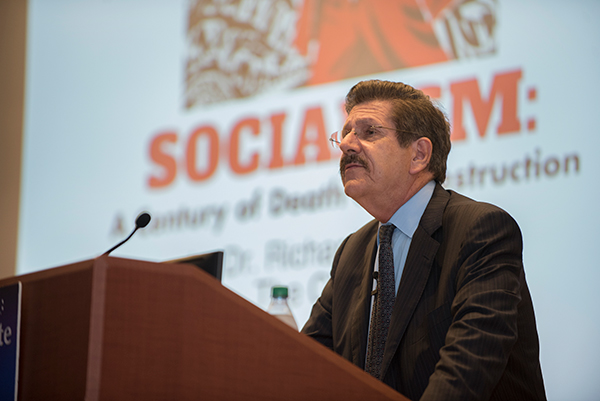 Professor giving a lecture on socialism, focusing on its historical context and implications.