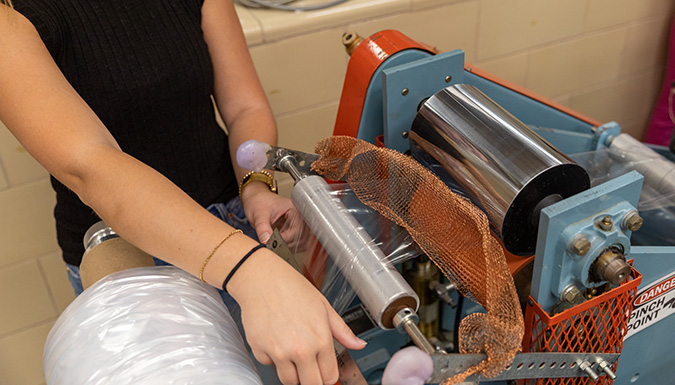student sealing an object
