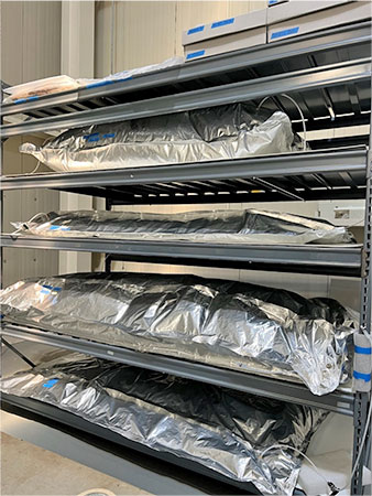 Materials on storage shelves in silver bags