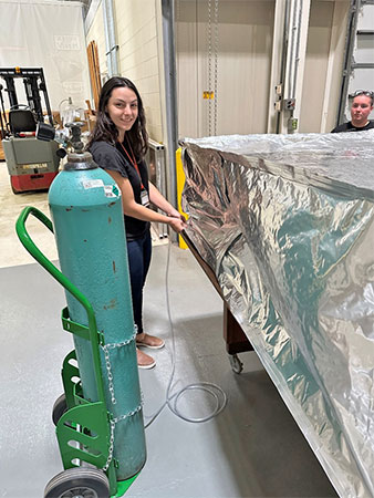 Worker in lab opening silver bag