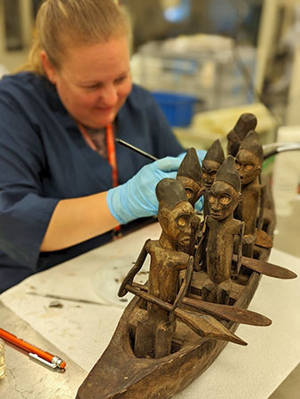 Wooden rowboat with figures