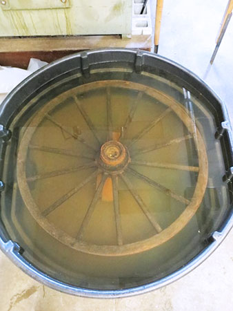 Wagon wheel submerged in solution