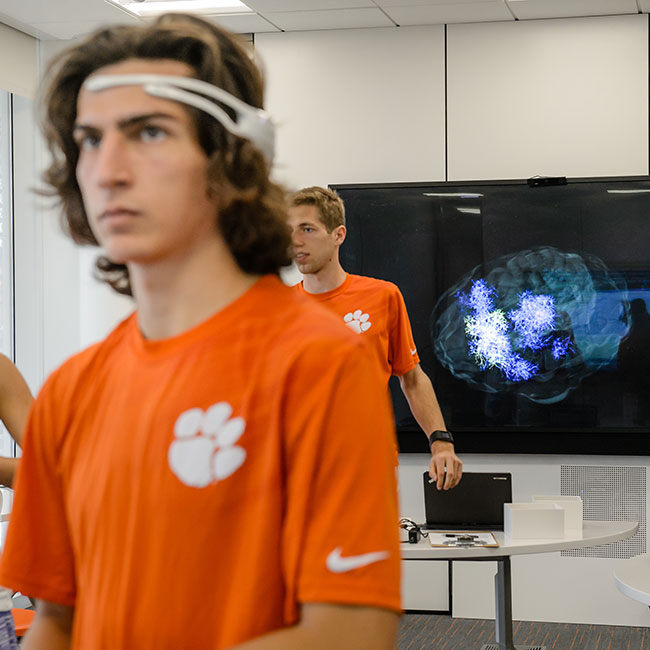 Students in class using equipment to see brain activity.