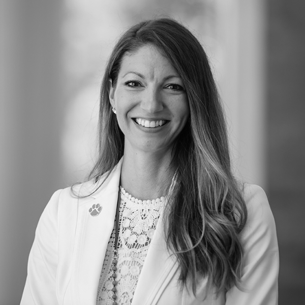 black and white photo of woman with long hair wearing white jacket.