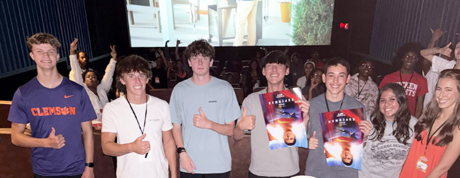 group of students smiling with thumbs up 