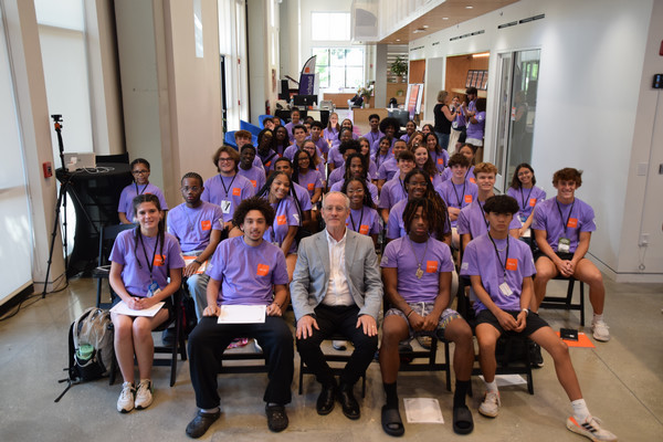 students and staff sitting in chairs