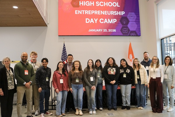 students and mentors standing at a podium