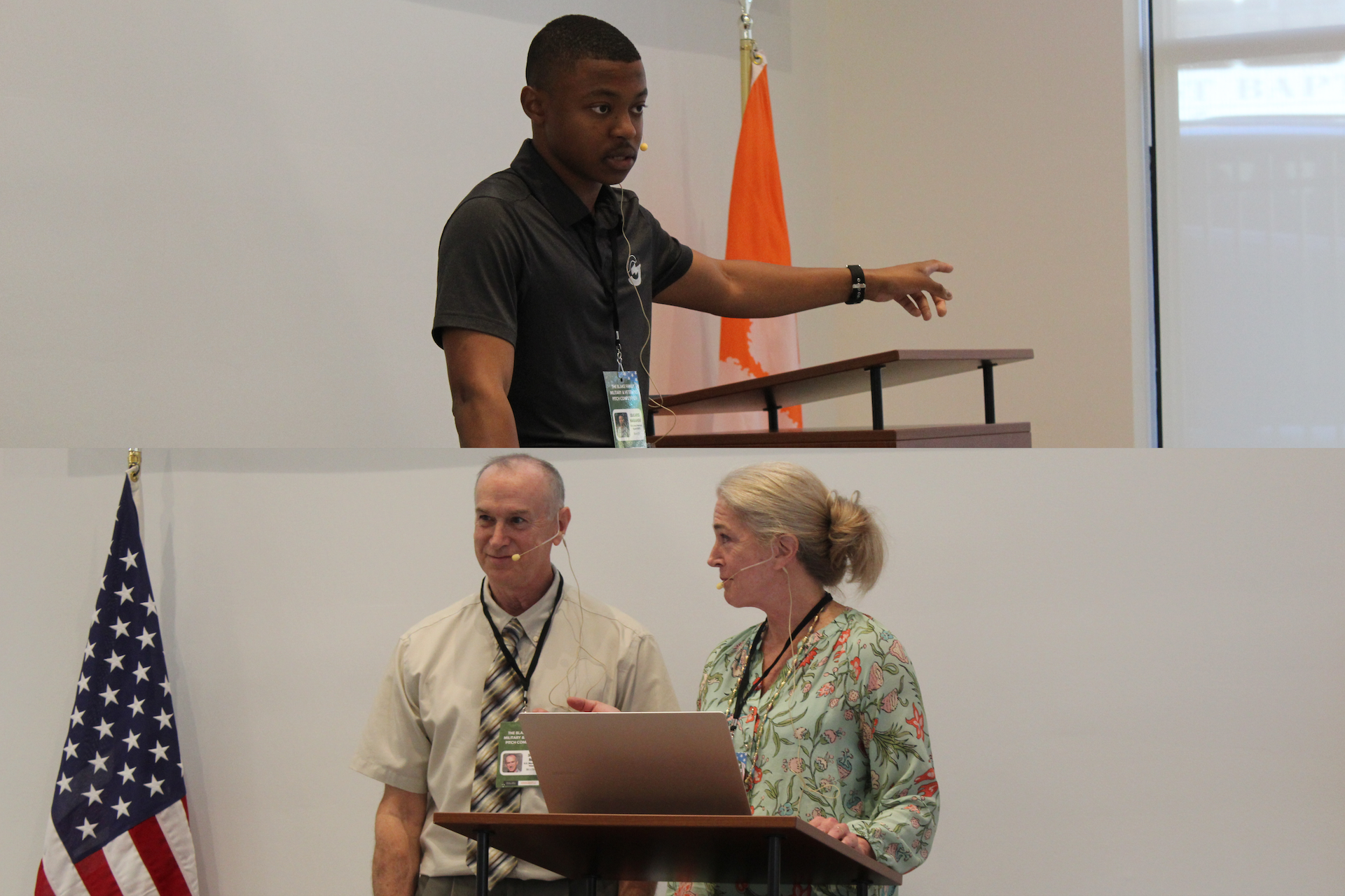 A speaker gestures while presenting at a podium, accompanied by two colleagues who are engaged in discussion. An American flag and an orange banner are visible in the background.